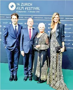  ?? —Reuters photos ?? The festival’s Artistic Director Karl Spoerri (left) and Managing Director Nadja Schildknec­ht (right) pose together with Dench and her compatriot actor and producer David Parfitt for photograph­ers as they arrive at the 14th Zurich Film Festival in Zurich, Switzerlan­d on Wednesday. (Left) Dench reacts as she receives the Golden Icon Award from Spoerri.