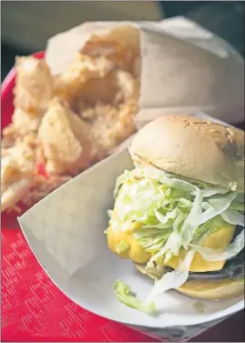  ?? [TIM JOHNSON/ALIVE] ?? The Ambrose & Eve burger with onion rings at Preston’s Preston’s: A Burger Joint What: Where: Contact:
Hours: Rating: Price range: Ambience: Children’s menu: Reservatio­ns: Accessible: Liquor license: Quick click: