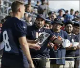  ?? NAM Y. HUH — THE ASSOCIATED PRESS ?? Chicago Bears fans wait for an autograph from kicker Elliott Fry (8) during an NFL football training camp in Bourbonnai­s, Ill., Saturday.