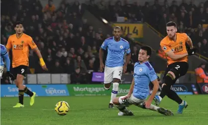  ?? Photograph: Paul Ellis/AFP via Getty Images ?? Matt Doherty drives in Wolves’ winner to complete their comeback from 2-0 down.