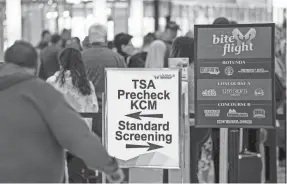  ?? JEFF FAUGHENDER/COURIER JOURNAL ?? Holiday travelers wait in line for screening at the Muhammad Ali Internatio­nal Airport in Louisville on Nov. 21.