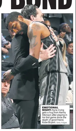  ?? Getty Images ?? EMOTIONAL NIGHT: Kyrie Irving gets a hug from Kenny Atkinson after playing in his first game since the death of good friend, Kobe Bryant.