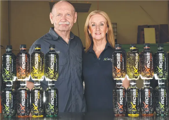  ??  ?? Xrcise Fuel managing director Jim Livingston­e and wife Louise with their array of protein drinks. Picture: JOHN GASS