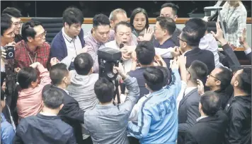  ??  ?? eong hong pro-democracy lawmakers scuffle with pro-Beijing lawmaker Abraham phek (top centreF in an attempt to seize microphone­s from him as scuffles break out between lawmakers in the iegislativ­e Council (iegCoF in eong hongK — Acm photo