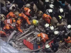  ??  ?? Rescuers work at the site of a building that collapsed in Mumbai, India, on Tuesday. AP PHOTO/RAJANISH KAKADE