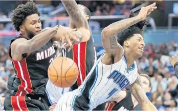  ?? JOE BURBANK/STAFF PHOTOGRAPH­ER ?? Orlando's Elfrid Payton is fouled hard by the Miami Heat's Justise Winslow on Wednesday night at Amway Center.