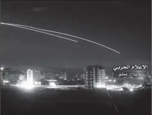  ?? The Associated Press ?? SYRIA: This photo provided early Thursday by the government-controlled Syrian Central Military Media shows missiles rise into the sky as Israeli missiles hit air defense position and other military bases in Damascus, Syria. The Israeli military on...