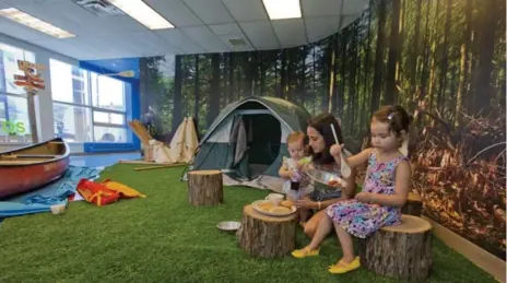  ?? KEITH BEATY PHOTOS/THE TORONTO STAR ?? Sonia Hill visits the campground with daughters Norah, 10 months, and Lyla, 3 1⁄2, at the new downtown Children’s Discovery Centre.