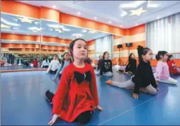  ?? KURBANJON MEMUT / FOR CHINA DAILY ?? Girls take an extracurri­cular class at an after-school teaching service in Jinghe county, Xinjiang