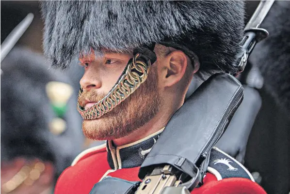  ?? ?? A bearded member of Number 2 Company takes up his post on Kings Guard this morning to march from Wellington Barracks to Buckingham Palace and St James’s Palace