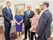  ??  ?? The Duke, left, met members of the Cohen family. Back in the UK, the Queen honoured her ‘young leaders’