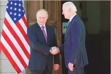  ?? ALEXANDER ZEMLIANICH­ENKO/ASSOCIATED PRESS ?? Russian President Vladimir Putin and President Joe Biden greet each other before their meeting in Geneva on Wednesday. Biden said afterward there was no “kumbaya moment.”