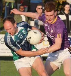  ??  ?? Peter Walsh (Volunteers) under pressure from John Doyle.