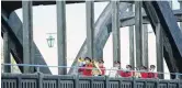  ??  ?? Members of the St Kilda Brass Band, pictured on the Balclutha bridge, say they would do it all again.