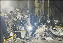  ?? Ukrainian Police Press Office photo via AP ?? Emergency personnel work on the site of a destroyed multi-store building after a Russian attack on residentia­l neighbourh­ood in Odesa, Ukraine, on Saturday.