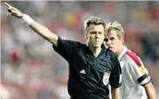  ?? EPA ?? Portugal, 2004: Urs Meier und der erboste Engländer Phil Neville.