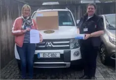  ??  ?? Cllr Maura Bell presents masks to Sinead Furlong of Civil Defence.