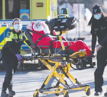  ?? THE CANADIAN PRESS/FILES ?? Paramedics wheel a patient into the emergency department at Mount Sinai Hospital in Toronto last month. Canada has been recording a rise in COVID-19 variants, including a type that originally spread in the U.K.