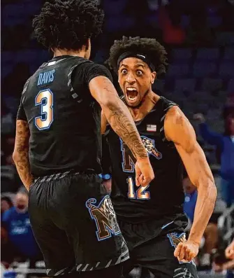  ?? LM Otero/Associated Press ?? Memphis forward DeAndre Williams, right, scored 16 points to go with 13 rebounds in a 75-65 win over No. 1 Houston in the American Athletic Conference title game.