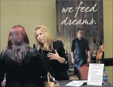  ?? Lynne Sladky AP ?? THE AVERAGE hourly earnings for all U.S. private-sector workers last month rose a solid 9 cents to $26.74. Above, Grace Ochoa of Performanc­e Food Service talks with an applicant this week at a job fair in Florida.