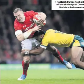  ??  ?? &gt; Hadleigh Parkes has held off the challenge of Owen Watkin at inside centre