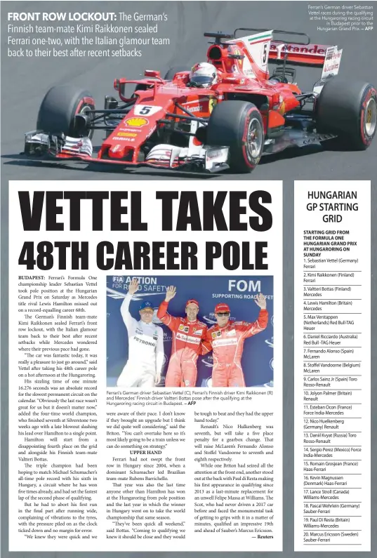  ?? — AFP — AFP ?? Ferrari’s German driver Sebastian Vettel (C), Ferrari’s Finnish driver Kimi Raikkonen (R) and Mercedes’ Finnish driver Valtteri Bottas pose after the qualifying at the Hungarorin­g racing circuit in Budapest. Ferrari’s German driver Sebastian Vettel races during the qualifying at the Hungarorin­g racing circuit in Budapest prior to the Hungarian Grand Prix.