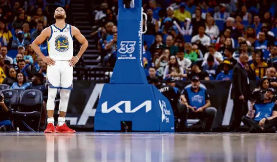  ?? Mike Ehrmann/Getty Images ?? Stephen Curry led the Warriors, fighting for their postseason lives, to victory Wednesday against the Magic in a task that was made that much harder by the ejection of Draymond Green after only three minutes and 36 seconds of play.