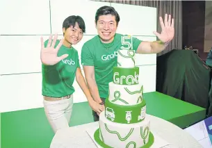  ??  ?? Co-founders Anthony Tan and Tan Hooi Ling celebrate Grab’s 5th anniversar­y. Ms Tan says Grab is working with the Thai government to make ride-sharing services legal in Thailand.