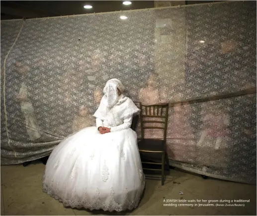  ?? (Ronen Zvulun/Reuters) ?? A JEWISH bride waits for her groom during a traditiona­l wedding ceremony in Jerusalem.