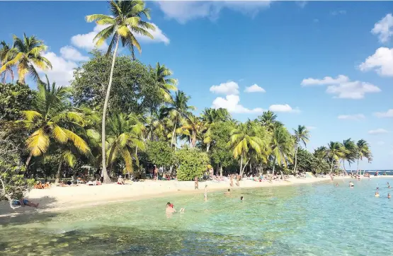  ?? PHOTOS: MAURA JUDKIS/THE WASHINGTON POST ?? Visitors enjoy the sun, sand and warm water of Plage de la Caravelle, a beach on Guadeloupe’s Grande-Terre island.