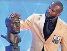  ?? AP-RON Schwane ?? Former NFL player Champ Bailey touches a bust of himself during the induction ceremony at the Pro Football Hall of Fame in Canton, Ohio, on Saturday.