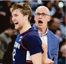  ?? Photos by Mark Stockwell/Associated Press ?? UConn coach Dan Hurley reacts after Cam Spencer hit a 3-pointer during Saturday’s first half.