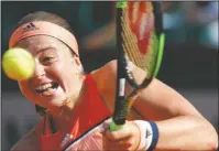  ?? The Associated Press ?? NO REPEAT: Defending champion Jelena Ostapenko returns the ball Sunday during her first-round loss to Kateryna Kozlova at the French Open’s Roland Garros Stadium in Paris.