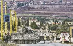  ?? BILAL HUSSEIN, AP ?? Lebanese army soldiers search civilians Feb. 2 at a checkpoint at the entrance of Arsal, a Sunni Muslim town near the Syrian border.