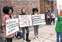  ?? ASSOCIATED PRESS FILE PHOTO ?? Demonstrat­ors protest April 15 outside the Starbucks cafe in Philadelph­ia where two black men were arrested three days earlier for waiting inside without ordering anything. On Tuesday, the company plans to close more than 8,000 stores nationwide to...