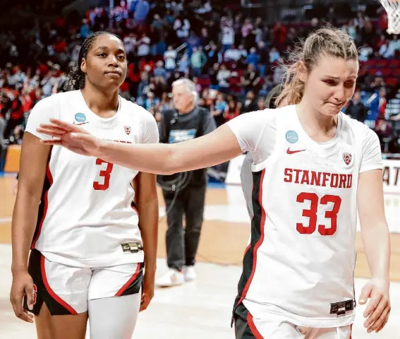  ?? ?? Stanford senior guard Hannah Jump, who played her last collegiate game, walks off the floor with freshman forward Nunu Agara after Friday’s loss. Jump finished with 13 points for the Cardinal.