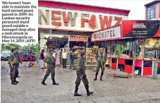 ?? (AFP) ?? We haven’t been able to maintain the hard earned peace gained in 2009. Sri Lankan security personnel stand guard outside a damaged shop after a mob attack in Minuwangod­a on May 14, 2019.