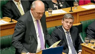  ?? PHOTO: GETTY IMAGES ?? Prime Minister Bill English looks on as Finance Minister Steven Joyce presents the 2017 Budget.