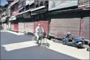  ?? AP ?? A man rides through a closed market during a shutdown in Srinagar on Monday. >>P7