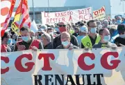  ?? /AFP ?? Taking a stand: Protester holds a CGT trade unions banner on Saturday as they demonstrat­e against Renault's decision to slash 4,600 jobs out of 48,000 in France.