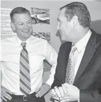  ?? MARK LONG/AP ?? UF athletic director Scott Stricklin smiles in November 2017 as he talks to Gators’ football coach Dan Mullen, who worked with Stricklin at Mississipp­i State before heading to Gainesvill­e to turn around the struggling football program.