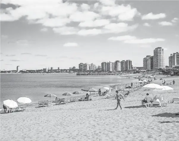  ?? GETTY IMAGES ?? People line a beach during a summer in the city of Punta del Este, Maldonado, the most famous seaside resort in Uruguay.