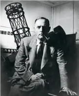  ?? HUB 1033 (11), EDWIN POWELL HUBBLE PAPERS, THE HUNTINGTON LIBRARY, SAN MARINO, CALIFORNIA ?? Edwin Hubble poses with a model of the telescope he used to unlock the nature of galaxies.