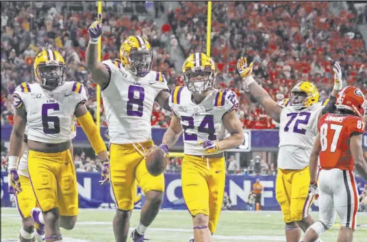  ?? John Bazemore The Associated Press ?? Louisiana State cornerback Derek Stingley Jr. celebrates with teammates his intercepti­on against Georgia on Saturday.