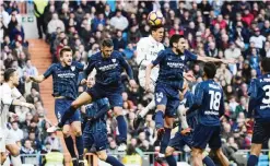  ??  ?? MADRID: Real Madrid’s French defender Raphael Varane (C) vies with Malaga’s defender Jose Luis (L) and Malaga’s midfielder Recio (R) during the Spanish league football match Real Madrid CF vs Malaga CF at the Santiago Bernabeu stadium in Madrid...