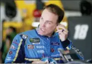  ?? MARY SCHWALM — THE ASSOCIATED PRESS FILE ?? In this file photo, driver Kevin Harvick puts in an ear piece as he prepares for practice for the NASCAR Cup Series auto race at New Hampshire Motor Speedway in Loudon, N.H. Harvick’s bid for a second NASCAR title suffered a massive setback when he was stripped of his berth in the championsh­ip race after series inspectors found his winning car from Texas Motor Speedway had been deliberate­ly altered to give him a performanc­e advantage.
