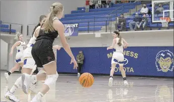  ??  ?? Lady Blackhawk senior Blakelee Winn, No. 22, dribbles toward the basket.