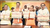  ?? PTI ?? UP CM Yogi Aditiyanat­h with state BJP president Mahendra Nath Pandey and Dy CMs Keshav Prasad Maurya and Dinesh Sharma releases the party’s Sankalpa Patra for the local bodies elections, at the party office in Lucknow on Sunday.