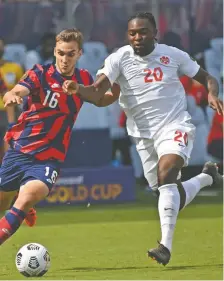  ?? PETER AIKEN/GETTY IMAGES ?? Ayo Akinola, right, injured his right knee during Canada's 1-0 Gold Cup loss to the U.S. on Sunday. The Toronto FC forward will miss the rest of the MLS season with a torn ACL.