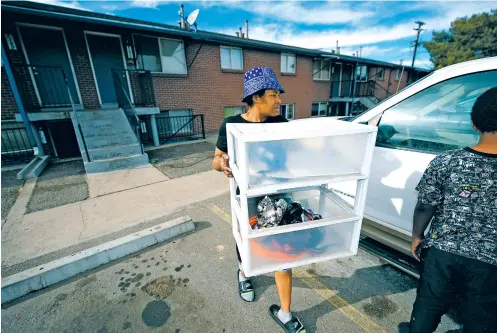  ?? ?? ABOVE: Monique Gant moves belongings out of an apartment after being evicted last month in Westminste­r, Colo. Monthly rent has outpaced income across the U.S. and forced many to make tough decisions between everyday necessitie­s and a home.